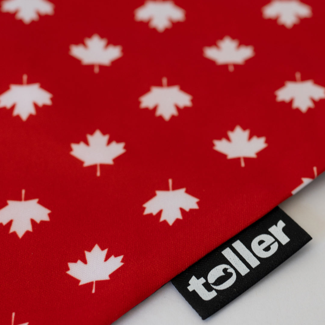 Red fabric with white maple leaf pattern and a 'toller' label.