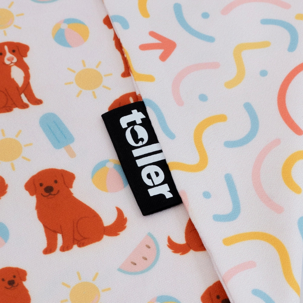 Fabric with dog and sun pattern and 'toller' brand label.