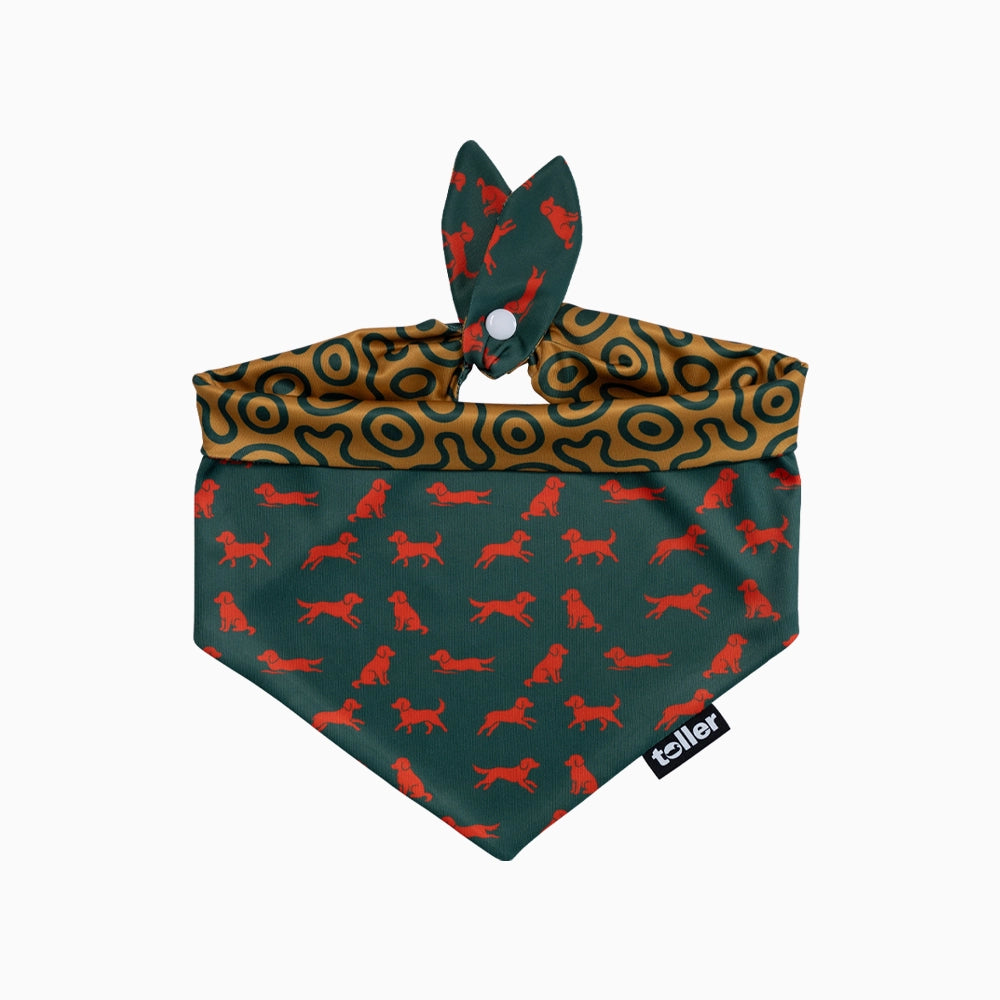 Dog bandana with red dog pattern on green background, featuring a dog-shaped accessory.