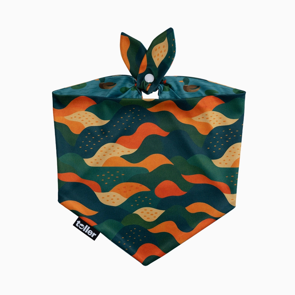 Dog bandana with wavy pattern in green, orange, and yellow on a white background