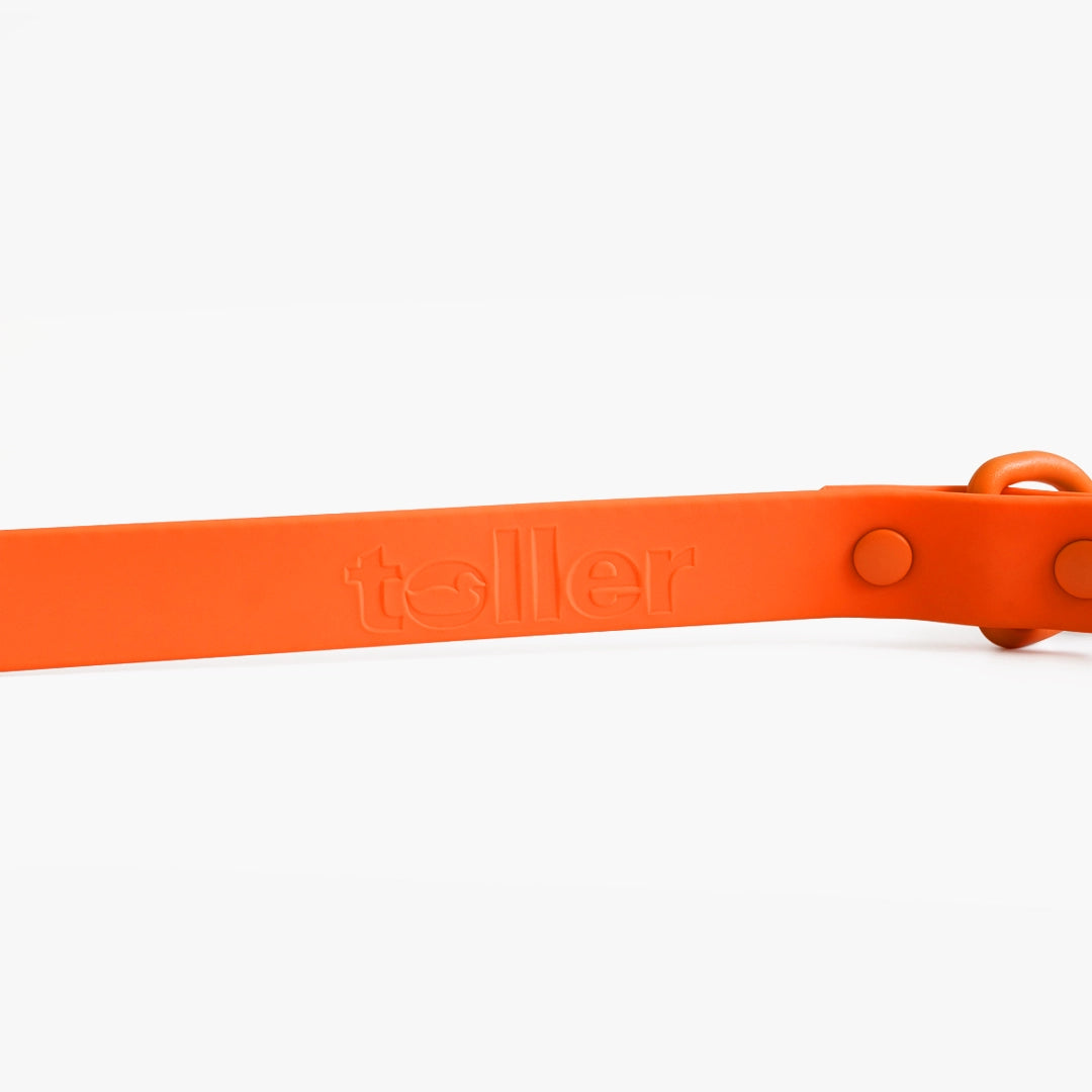 Orange silicone band with 'toller' branding on a white background