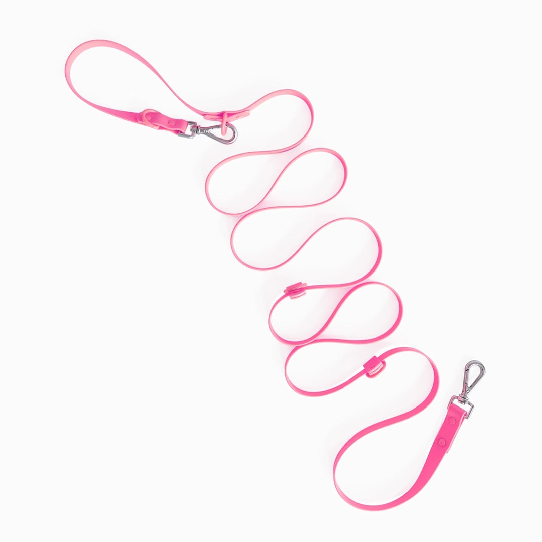 Pink dog leash with metal clip on a white background