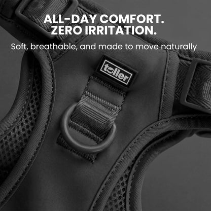 Black dog harness with 'Toller' brand label on a dark background, featuring comfort and irritation text.