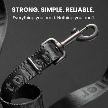 Dog leash with metal clip on a dark background, featuring the brand 'Tough'.