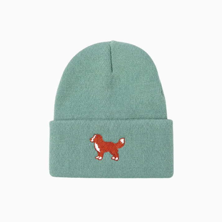 Green beanie with a red dog illustration on a white background
