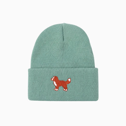 Green beanie with a red dog illustration on a white background