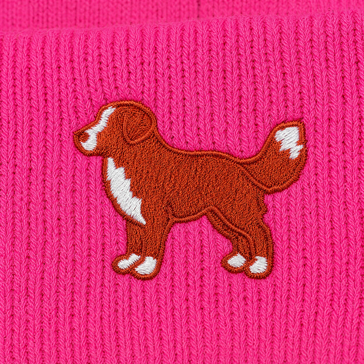 Embroidered dog design on a pink knitted fabric
