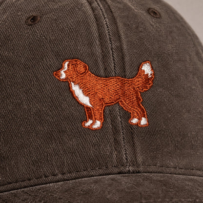Brown cap with embroidered dog design on a plain background