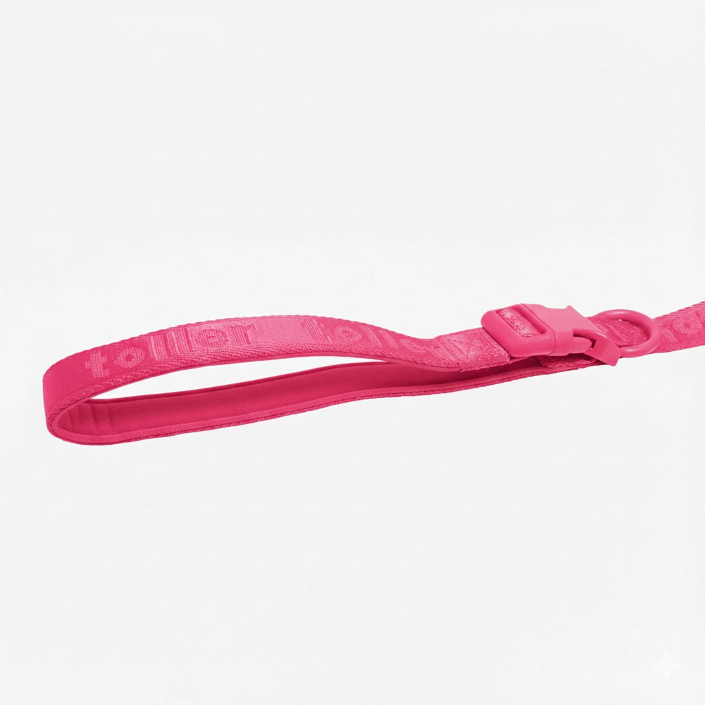 Pink dog leash with a brand logo on a white background