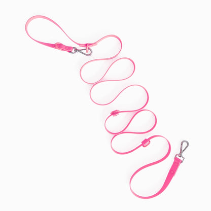 Pink dog leash with metal clip on a white background