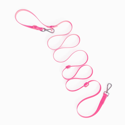 Pink dog leash with metal clip on a white background
